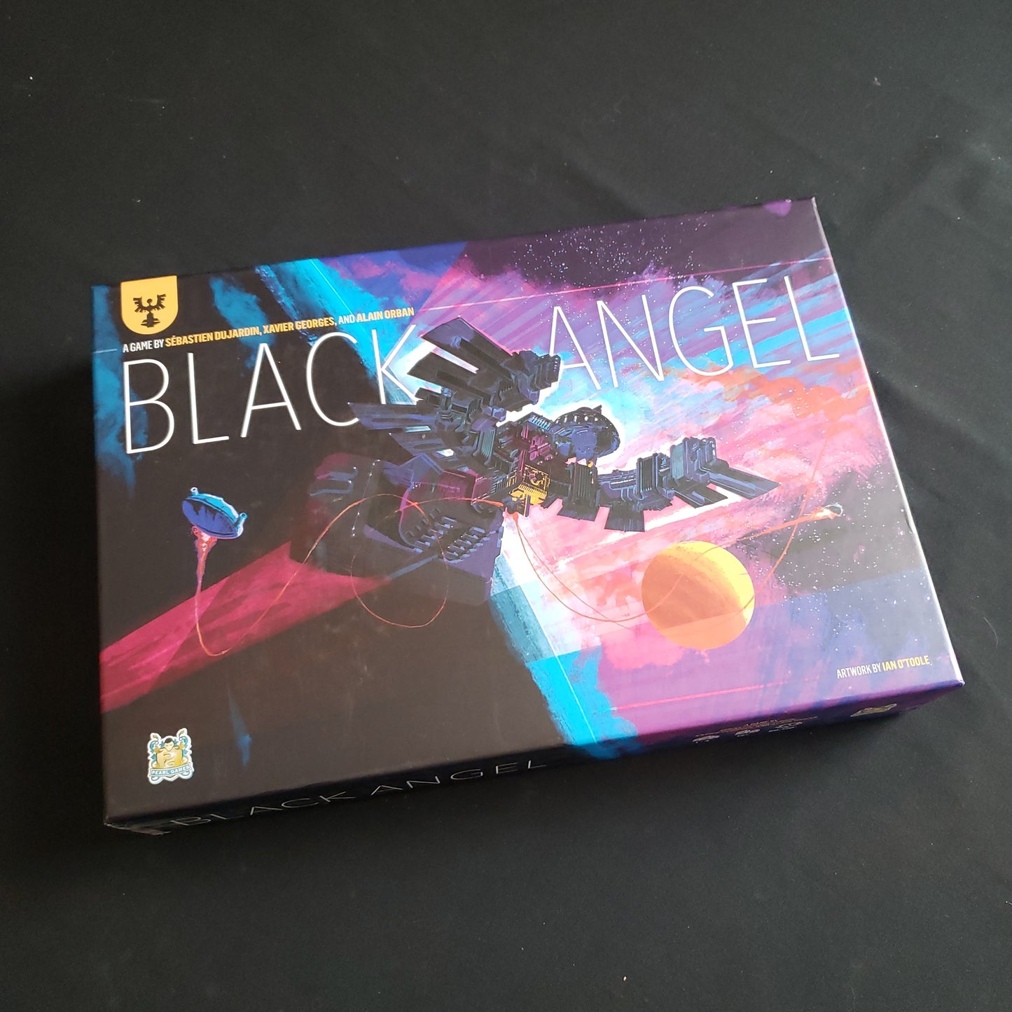 Image shows the front cover of the box of the Black Angel board game