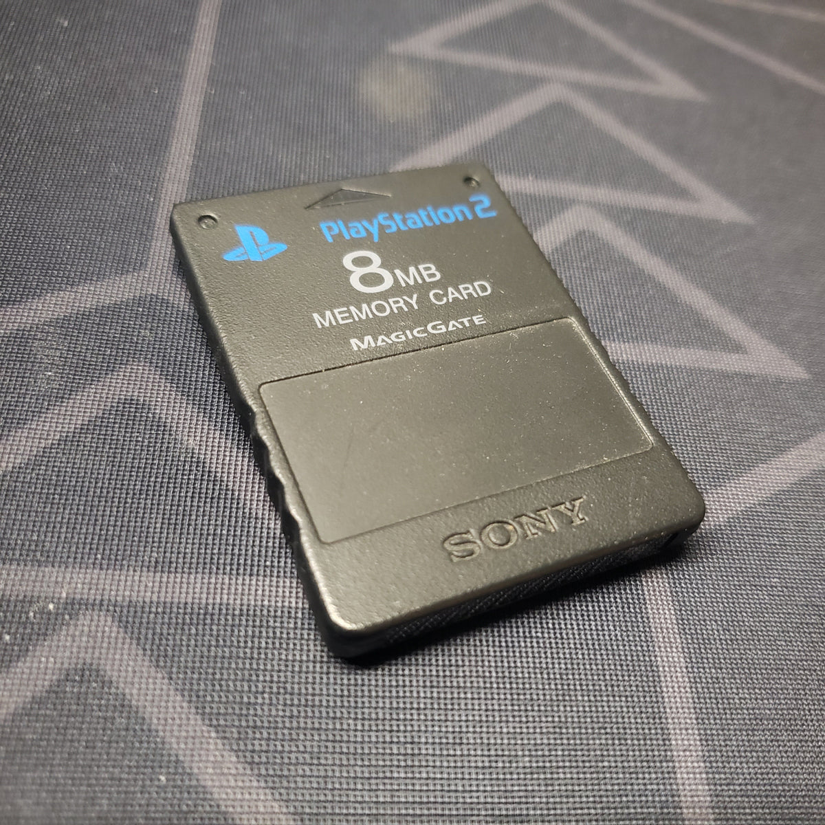 Image shows the front of a black Sony 8MB Memory Card for the Playstation 2 video game system