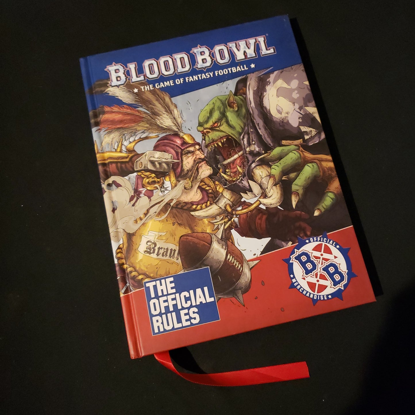 Image shows the front cover of the Official Rules book for the Blood Bowl miniatures game
