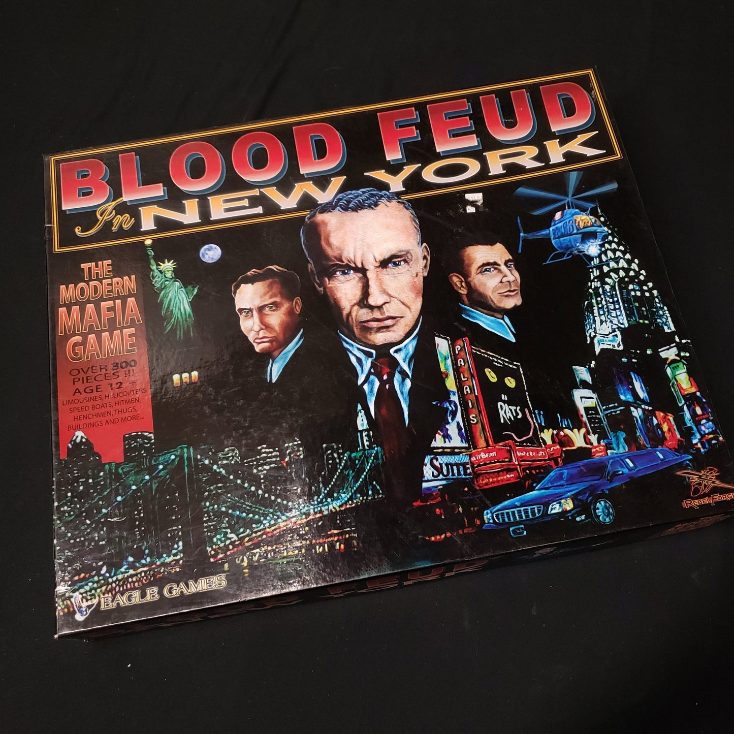 Image shows the front cover of the box of the board game Blood Feud in New York