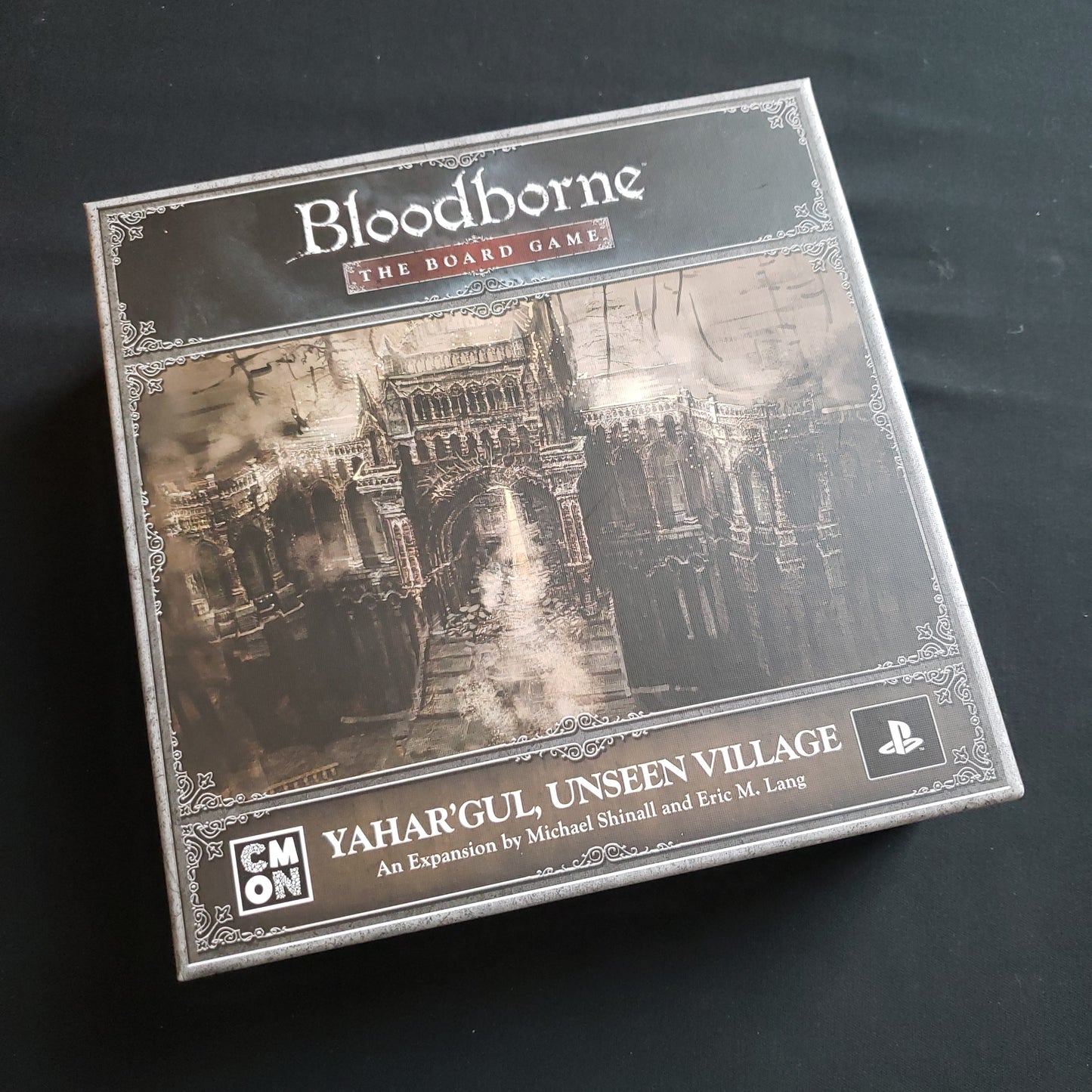 Image shows the front cover of the box of the Yahar'gul, Unseen Village expansion for the Bloodborne board game
