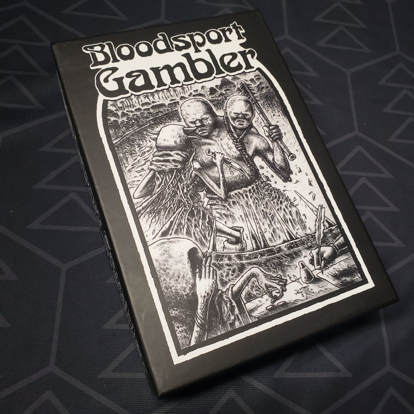 Image shows the front cover of the box for the Bloodsport Gambler card game