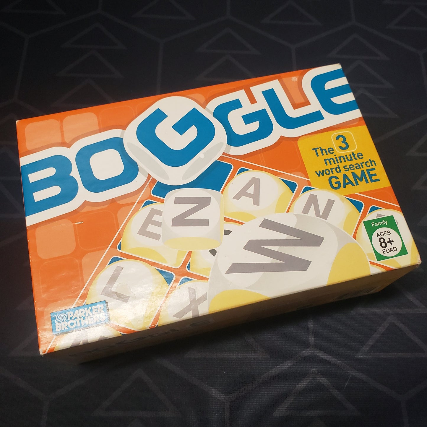 Image shows the front cover of the box for the Boggle dice game