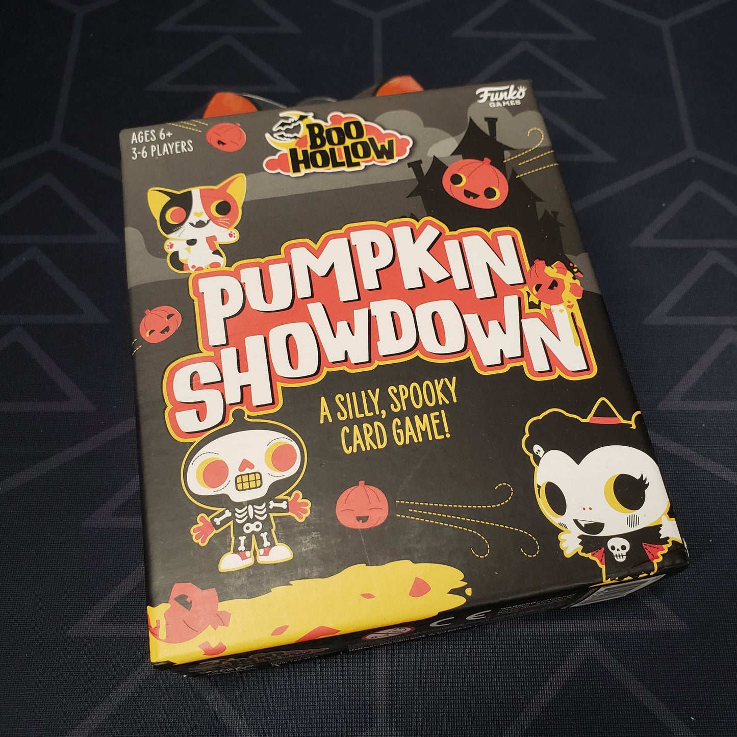 Image shows the front cover of the box of the Boo Hollow: Pumpkin Showdown card game