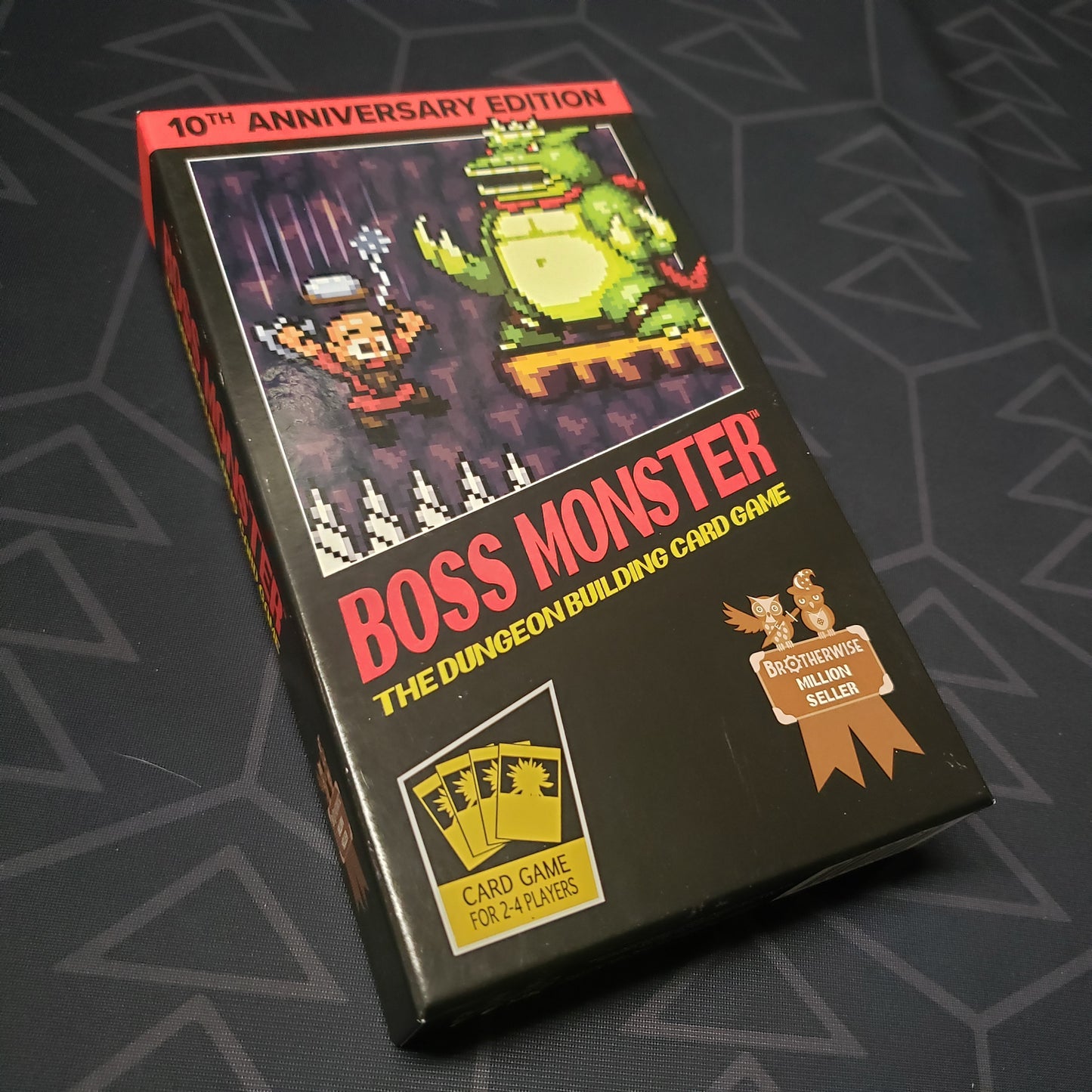 Image shows the front cover of the box of the Boss Monster: 10th Anniversary Edition card game