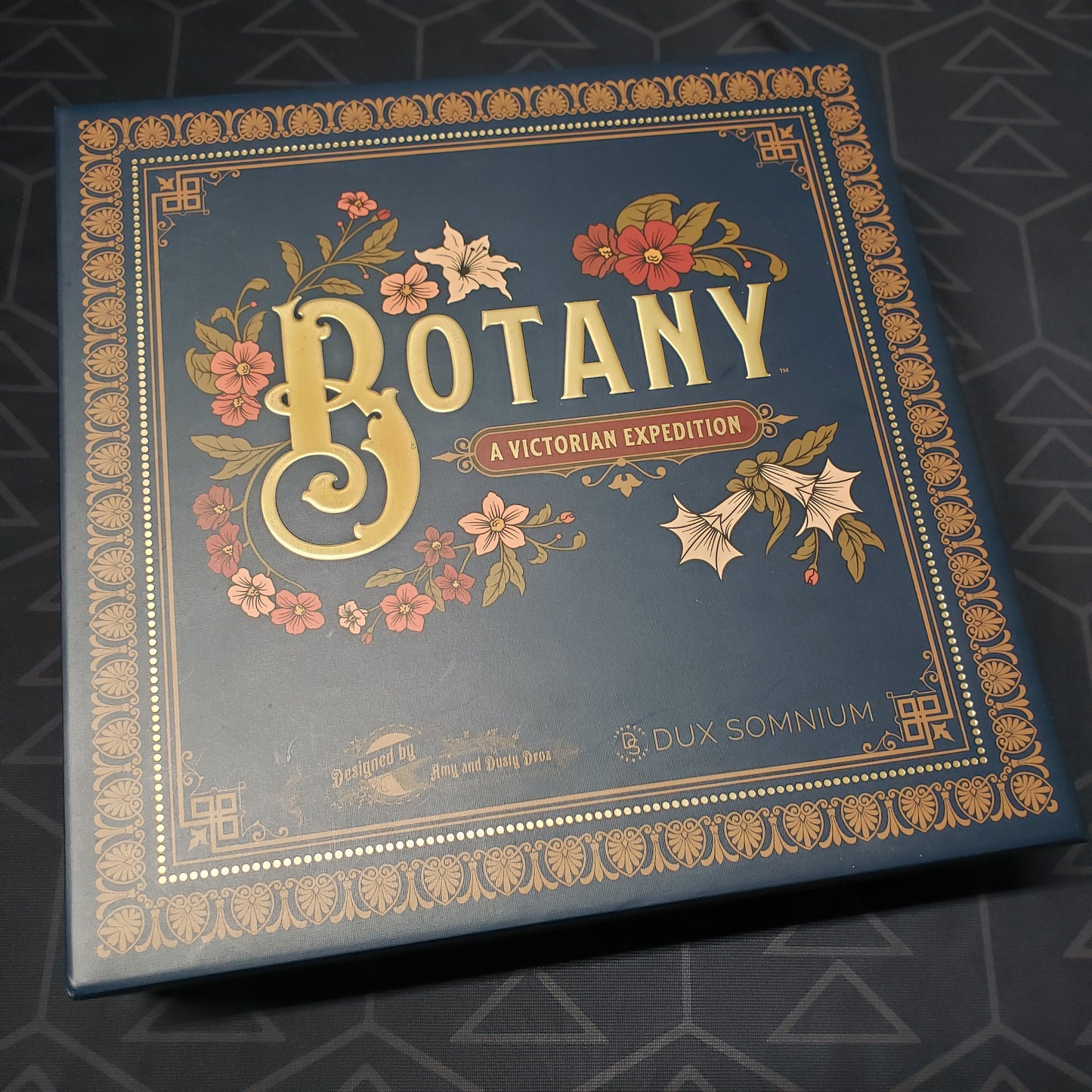 Image shows the front cover of the box of the Botany board game