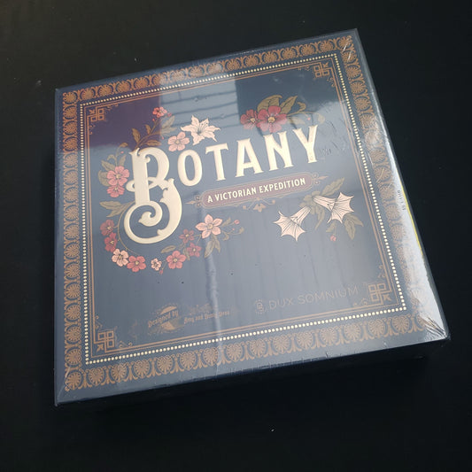 Image shows the front cover of the box of the Botany board game