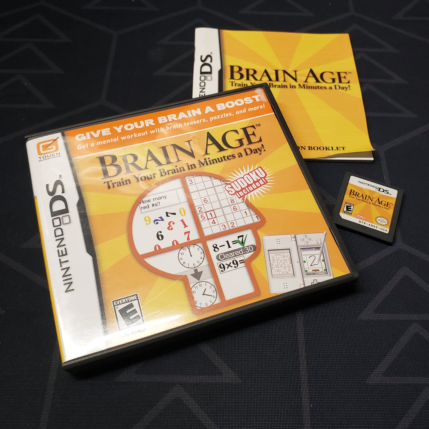 Image shows the case, manual & cartridge for the video game Brain Age for Nintendo DS