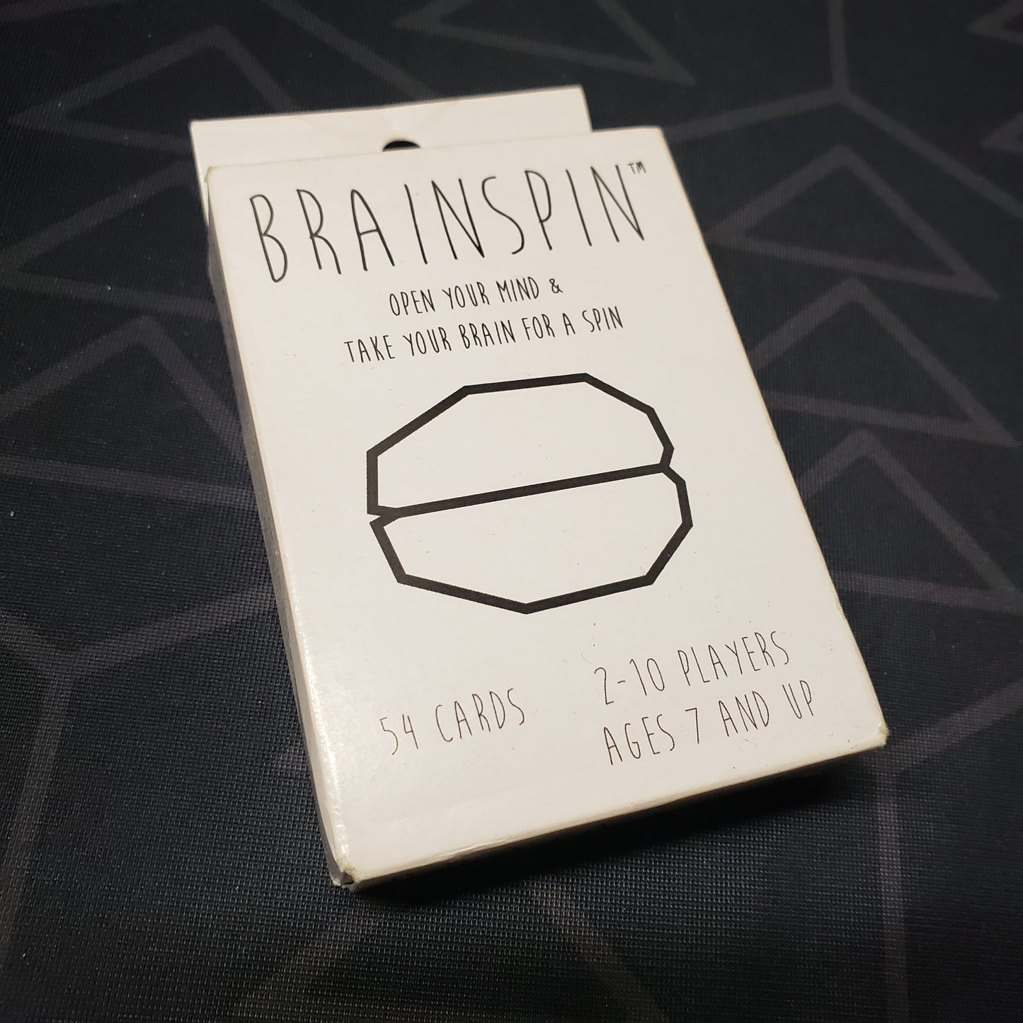 Image shows the front cover of the box for the BrainSpin card game