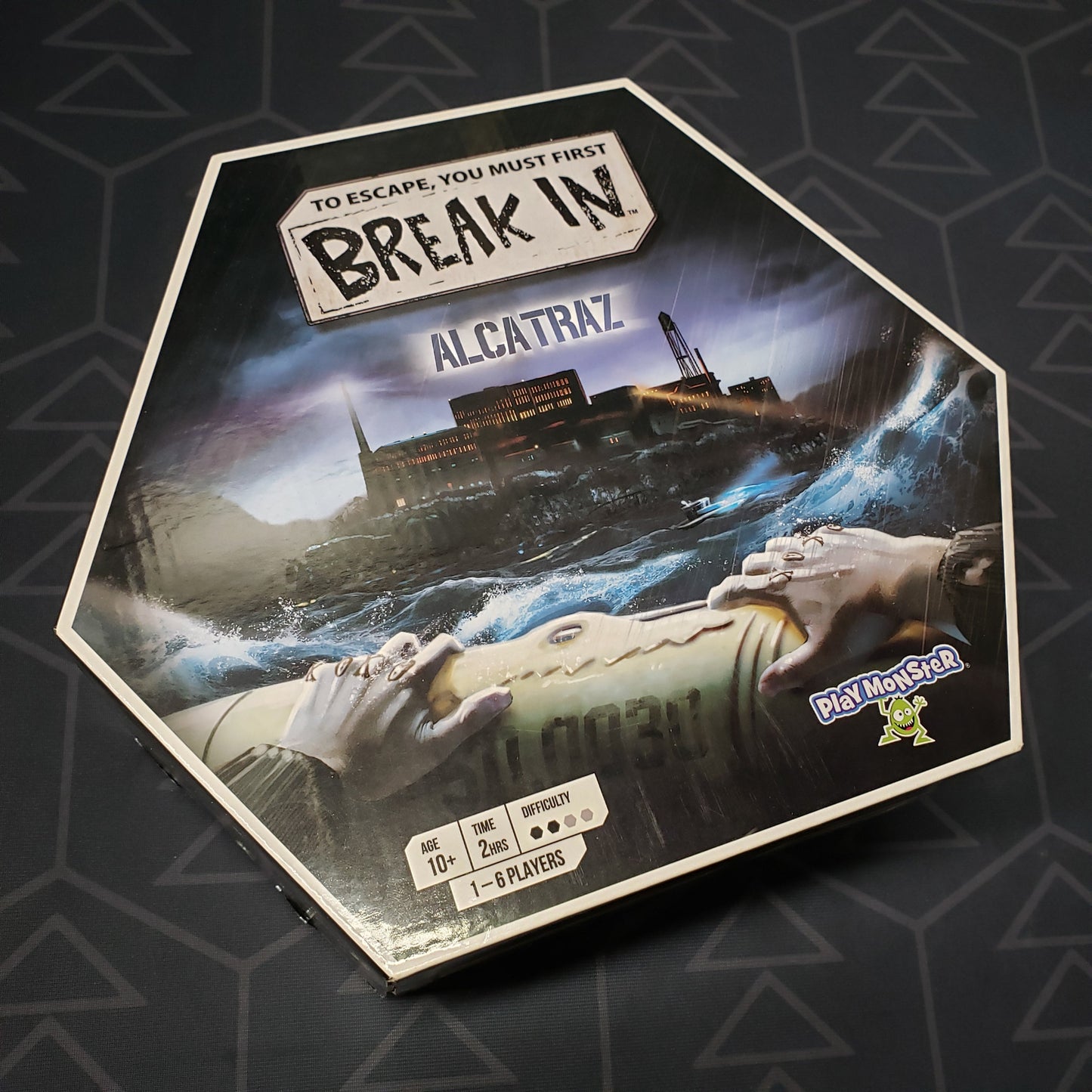Image shows the front cover of the box for the Break In: Alcatraz board game