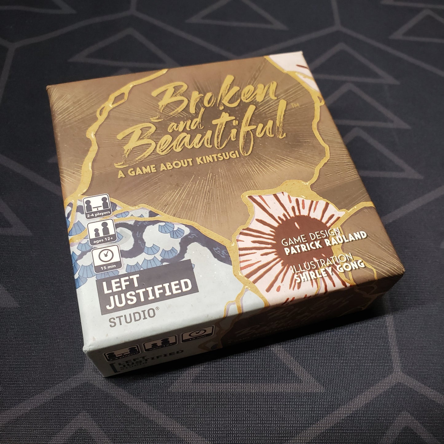 Image shows the front cover of the box for the Broken and Beautiful card game