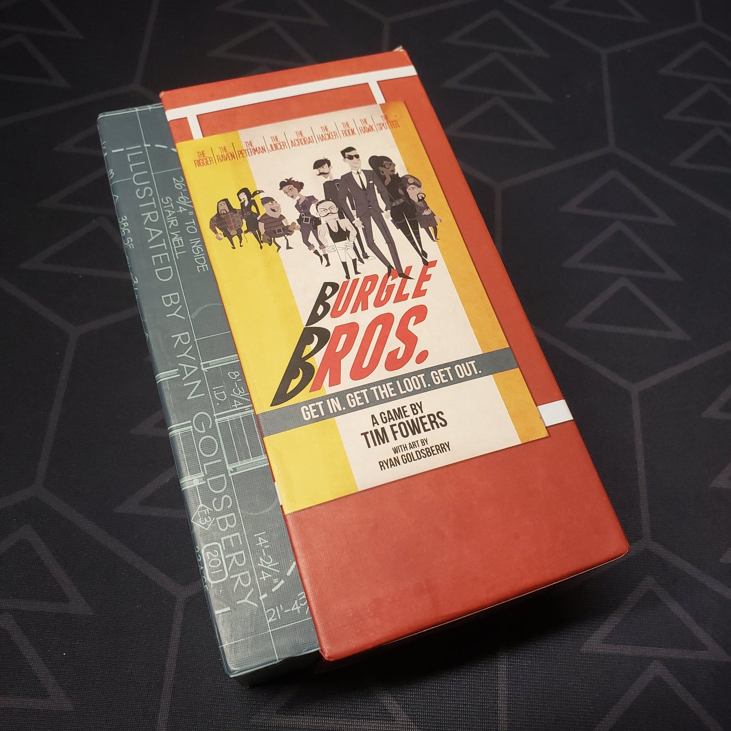 Image shows the front cover of the box of the Burgle Bros. board game