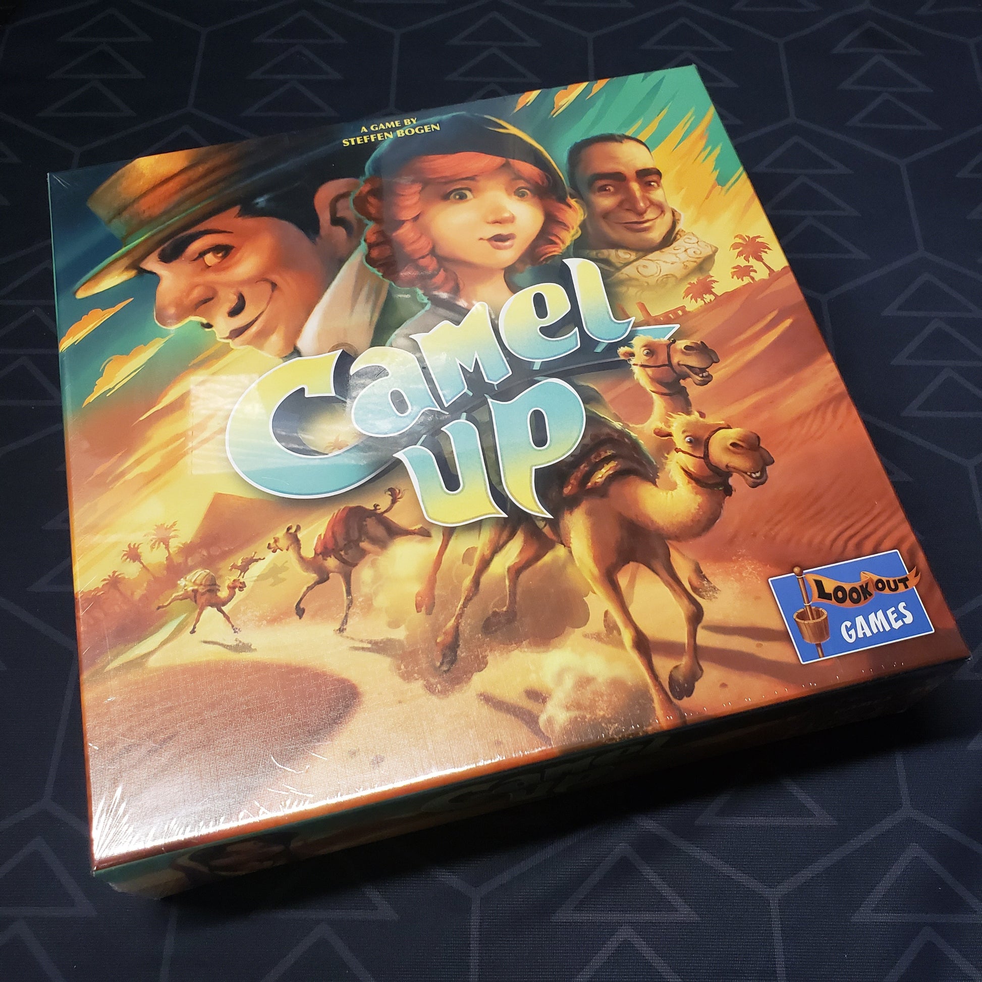 Image shows the front cover of the box of the Camel Up board game