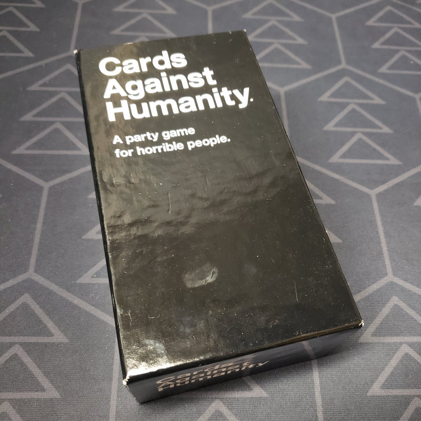 Image shows the front cover of the box for the Cards Against Humanity card game
