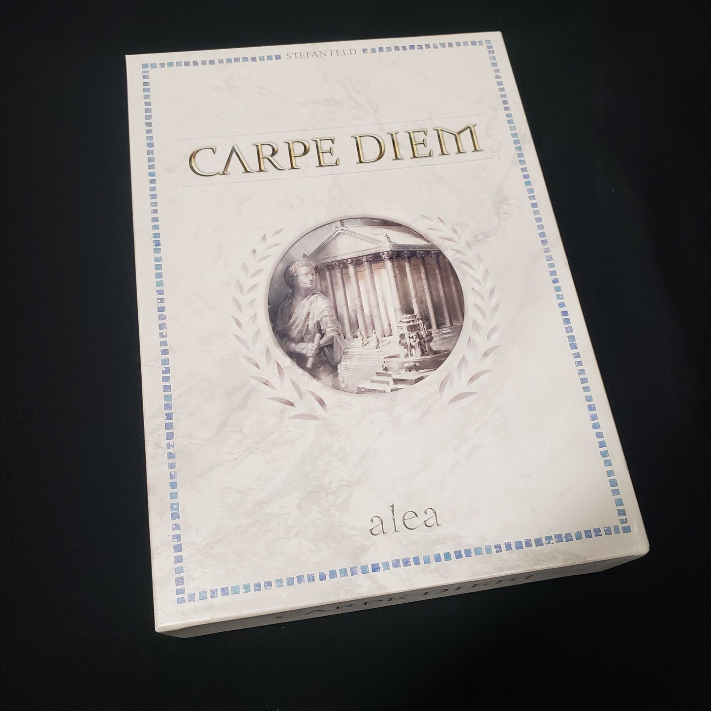 Image shows the front cover of the box of the board game Carpe Diem (Second Edition)
