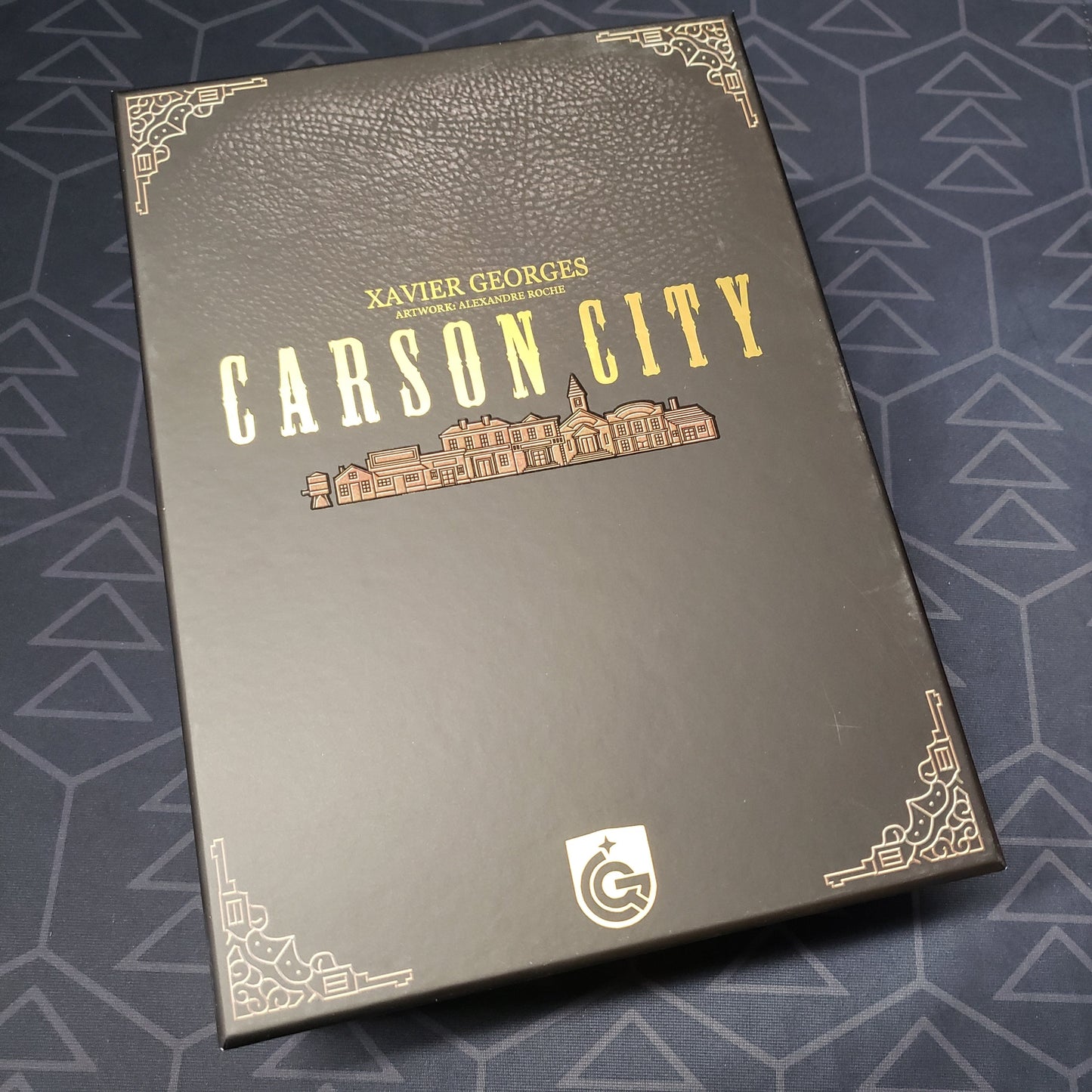 Image shows the front cover of the Big Box Edition of the board game Carson City