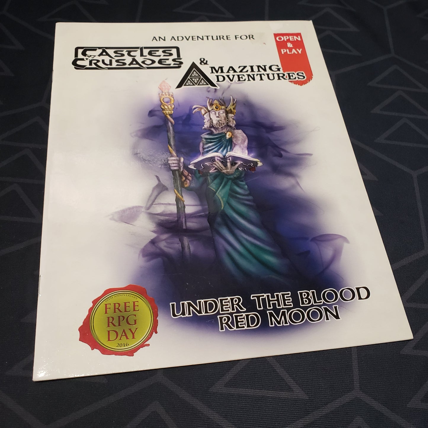 Image shows the front cover of the Under the Blood Red Moon book for the roleplaying game Castles & Crusades