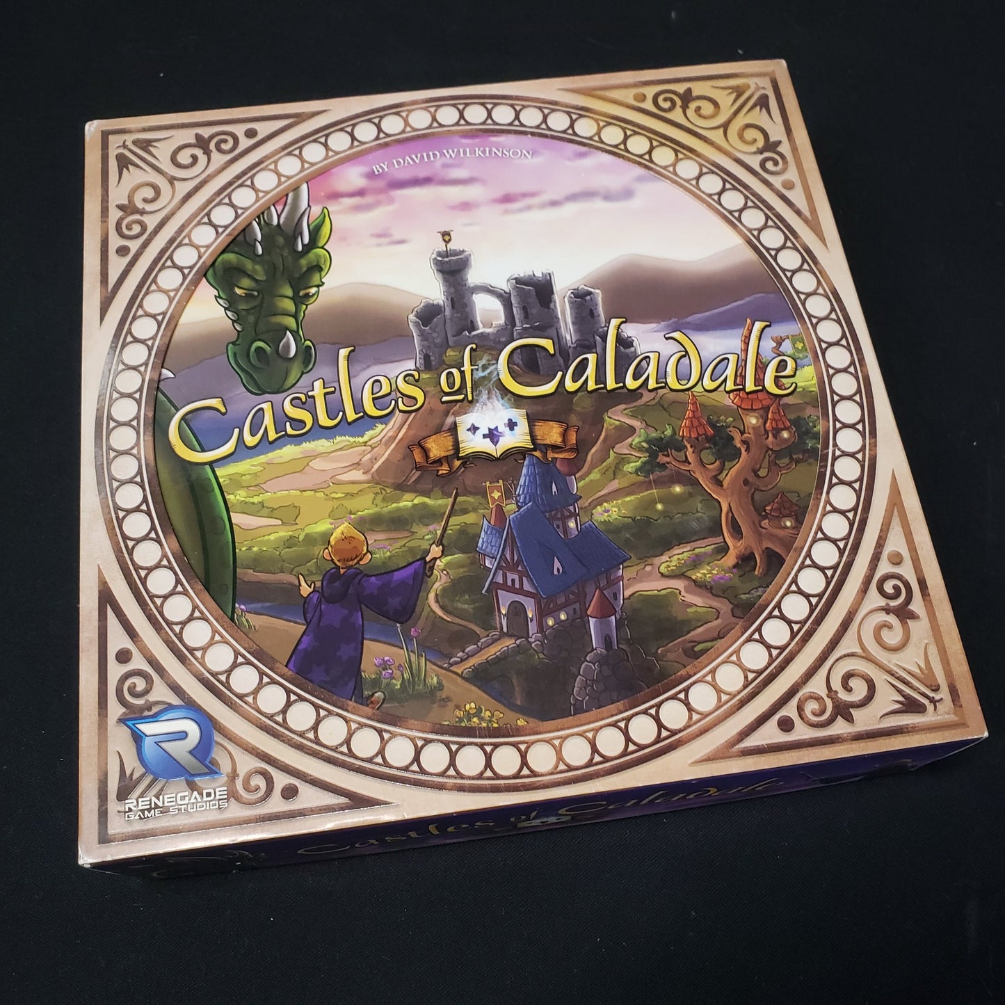 Image shows the front cover of the box of the Castles of Caladale board game