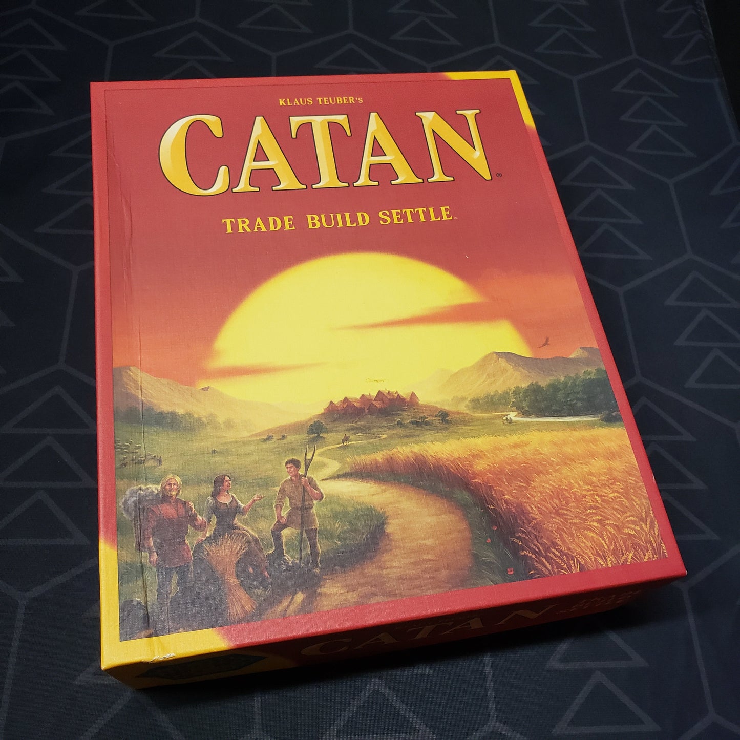 Image shows the front cover of the box of the Catan board game