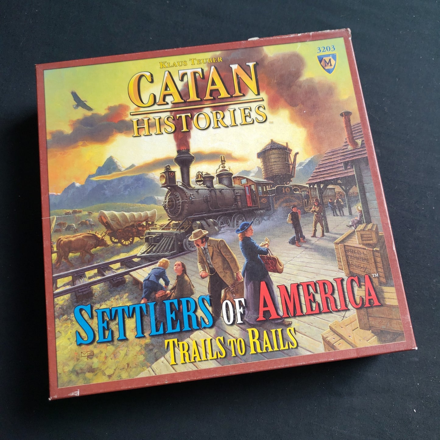 Image shows the front cover of the box of the Catan Histories: Settlers of America board game