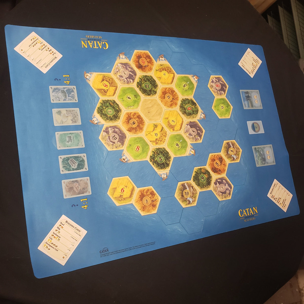 Image shows a gaming playmat for the Catan Seafarers expansion with a board layout printed on it