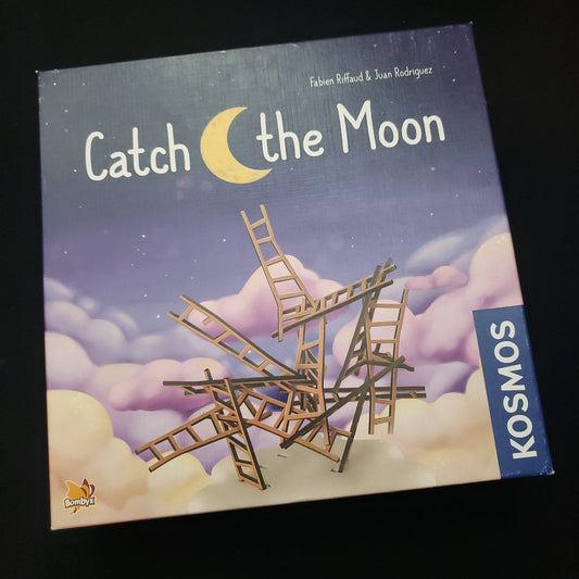 Image shows the front cover of the box of the Catch the Moon board game