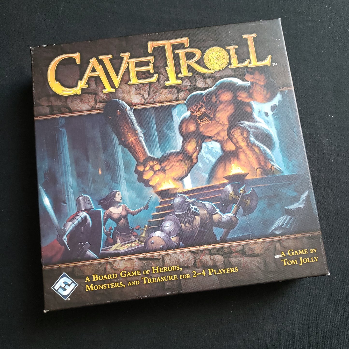 Image shows the front cover of the box of the Cave Troll board game