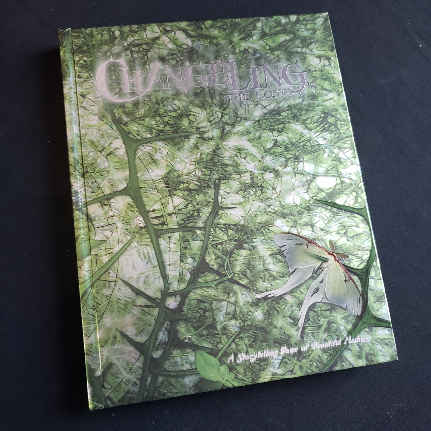 Image shows the front cover of the core rulebook for the roleplaying game Changeling: The Lost