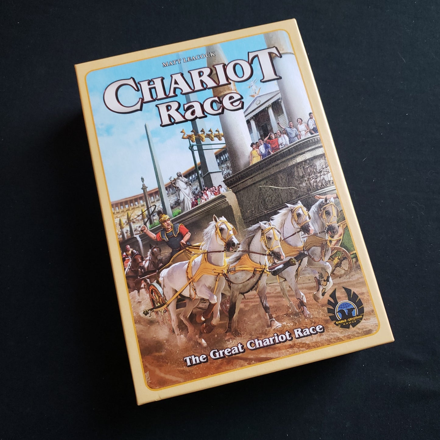 Image shows the front cover of the box of the Chariot Race board game