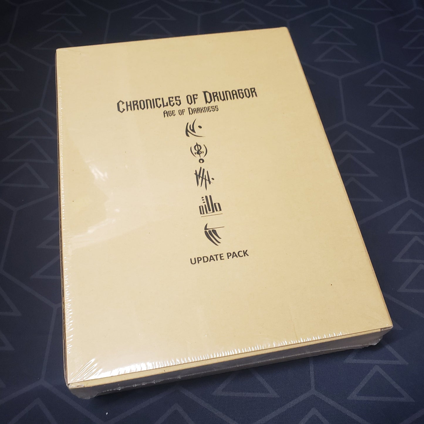 Image shows the front cover of the box of the Update Pack for the board game Chronicles of Drunagor: Age of Darkness