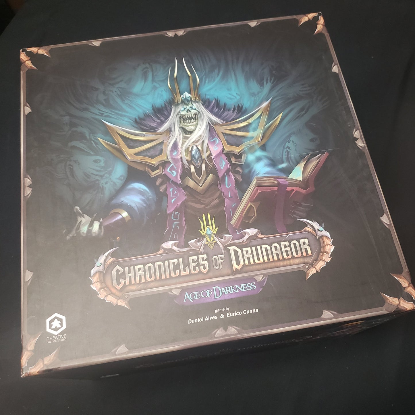 Image shows the front cover of the box of the Chronicles of Drunagor: Age of Darkness board game