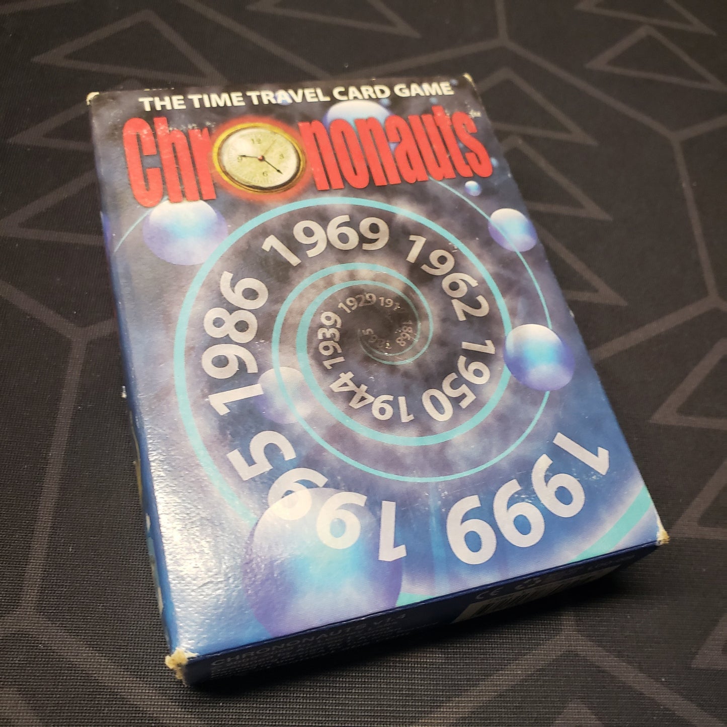 Image shows the front cover of the box of the Chrononauts card game