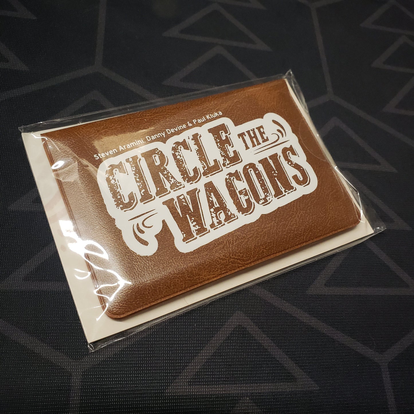 Image shows the front of the card wallet for the Circle the Wagons card game