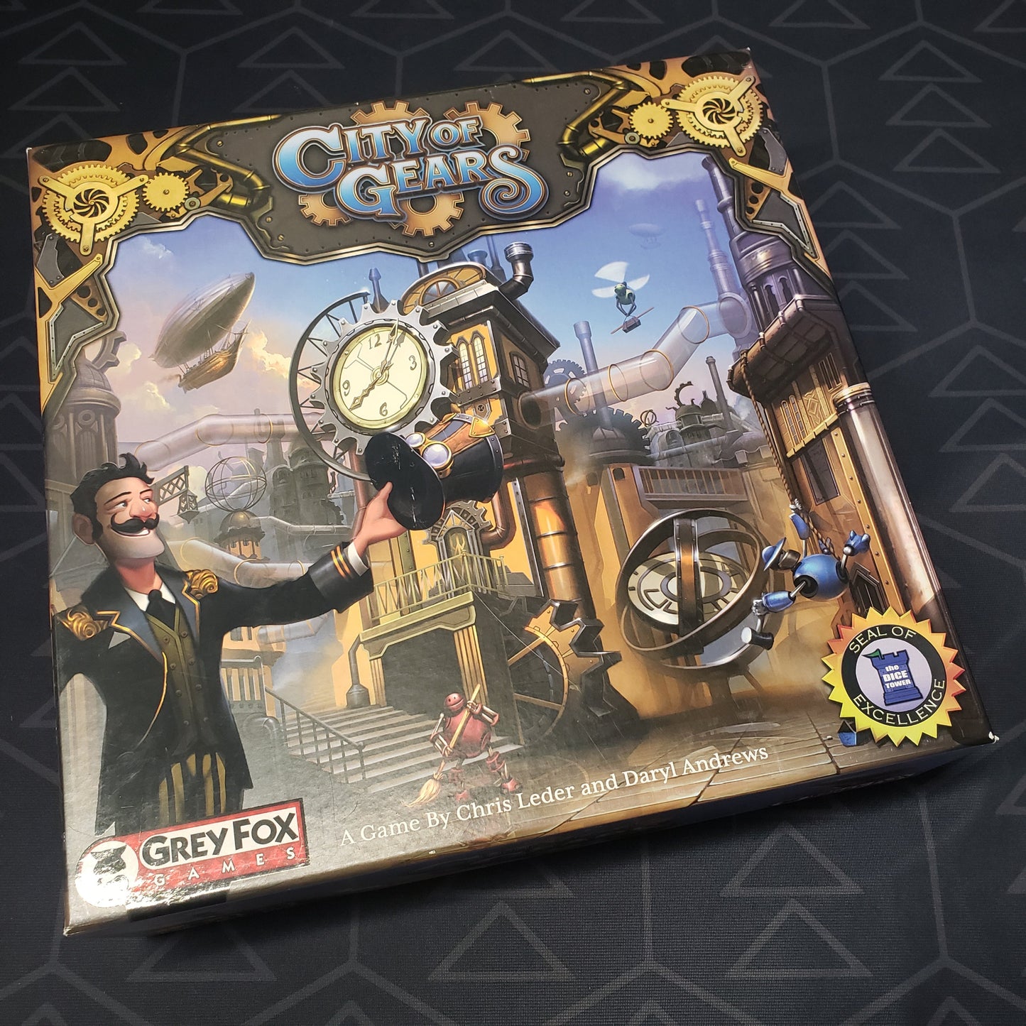 Image shows the front cover of the box of the City of Gears board game