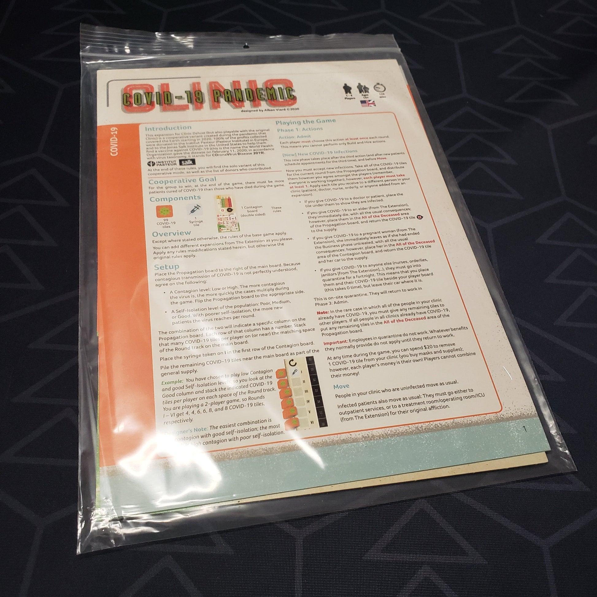 Image shows the front of the packaging for the COVID-19 Pandemic expansion for the board game Clinic: Deluxe Edition