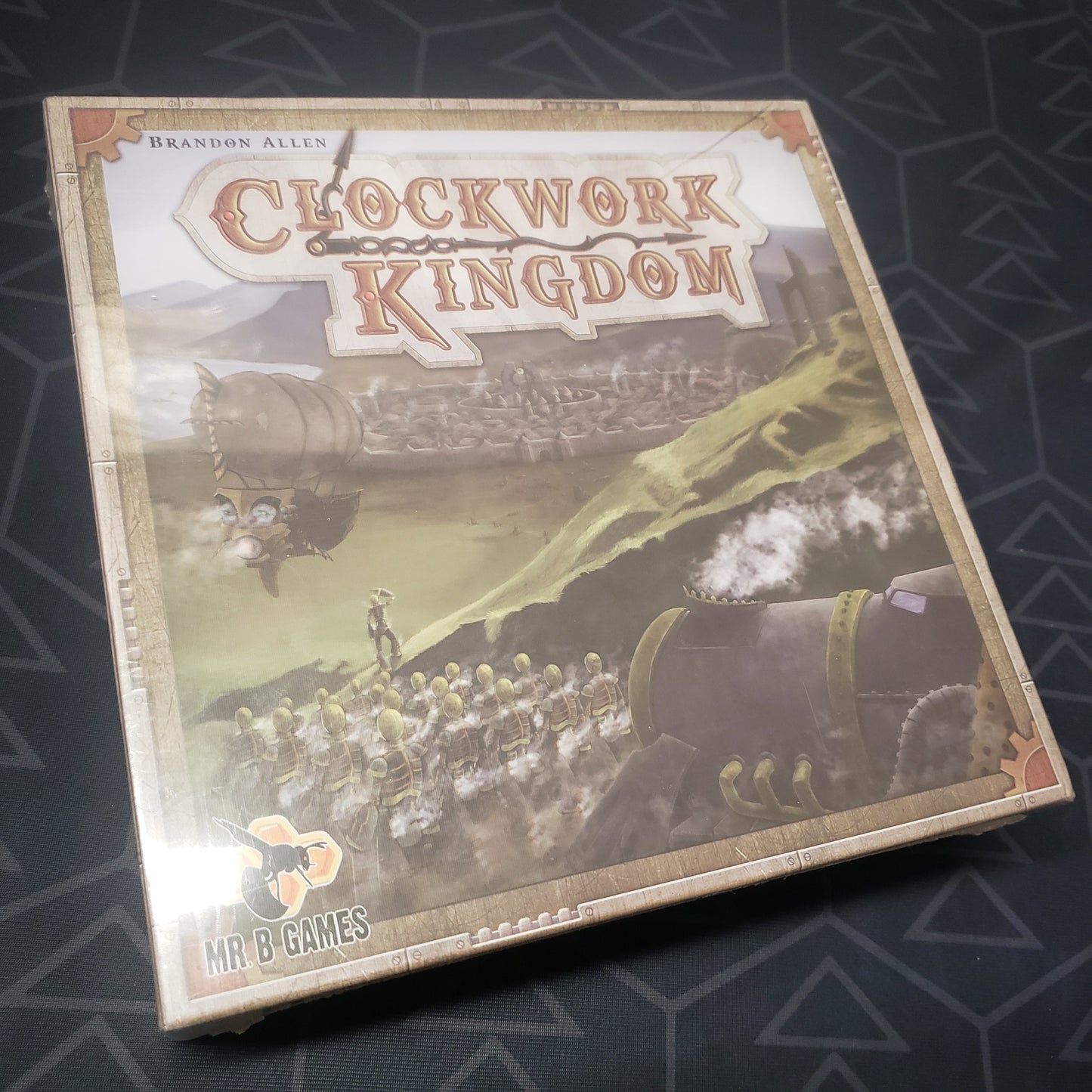 Image shows the front cover of the box for the Clockwork Kingdom board game