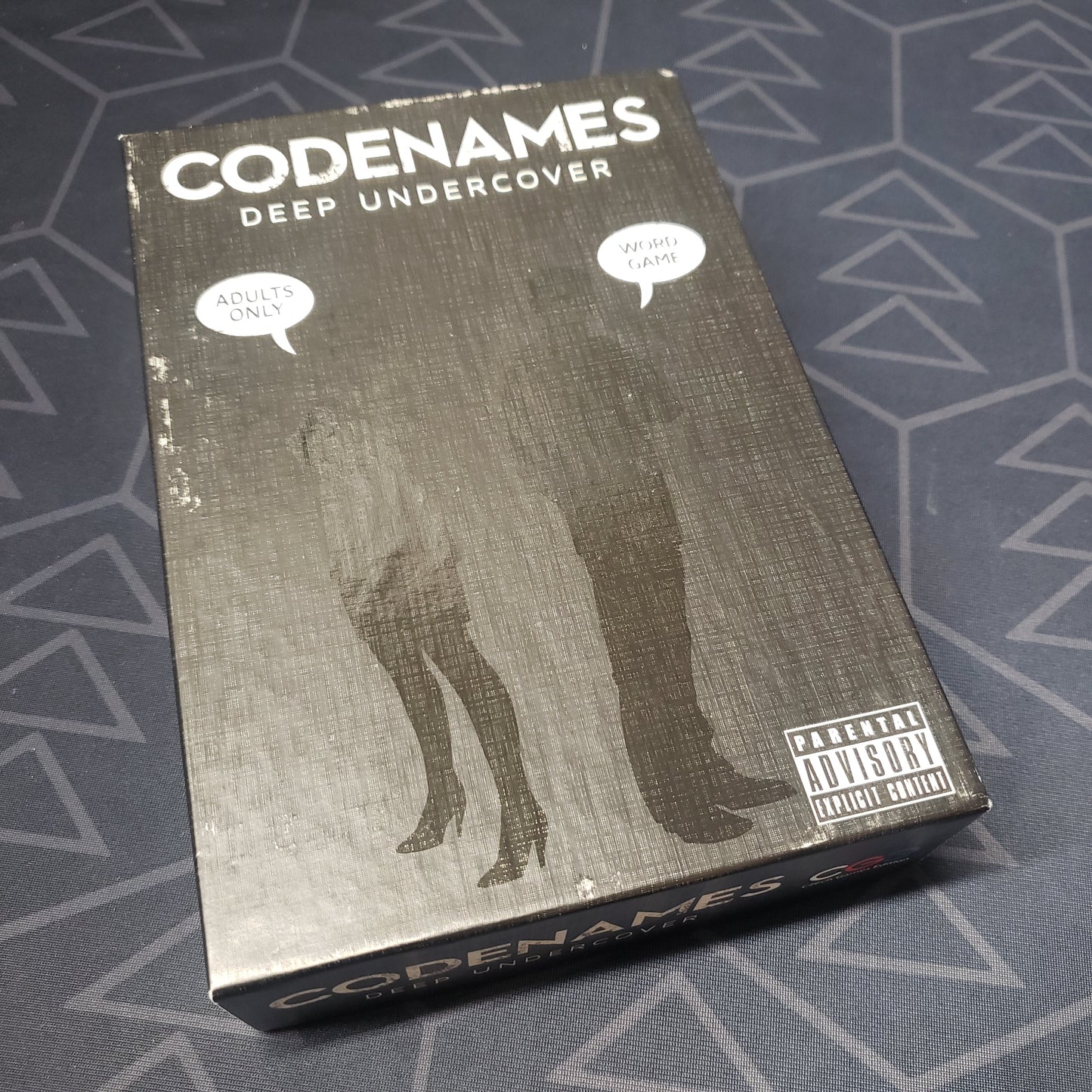Image shows the front cover of the box of the Codenames: Deep Undercover card game
