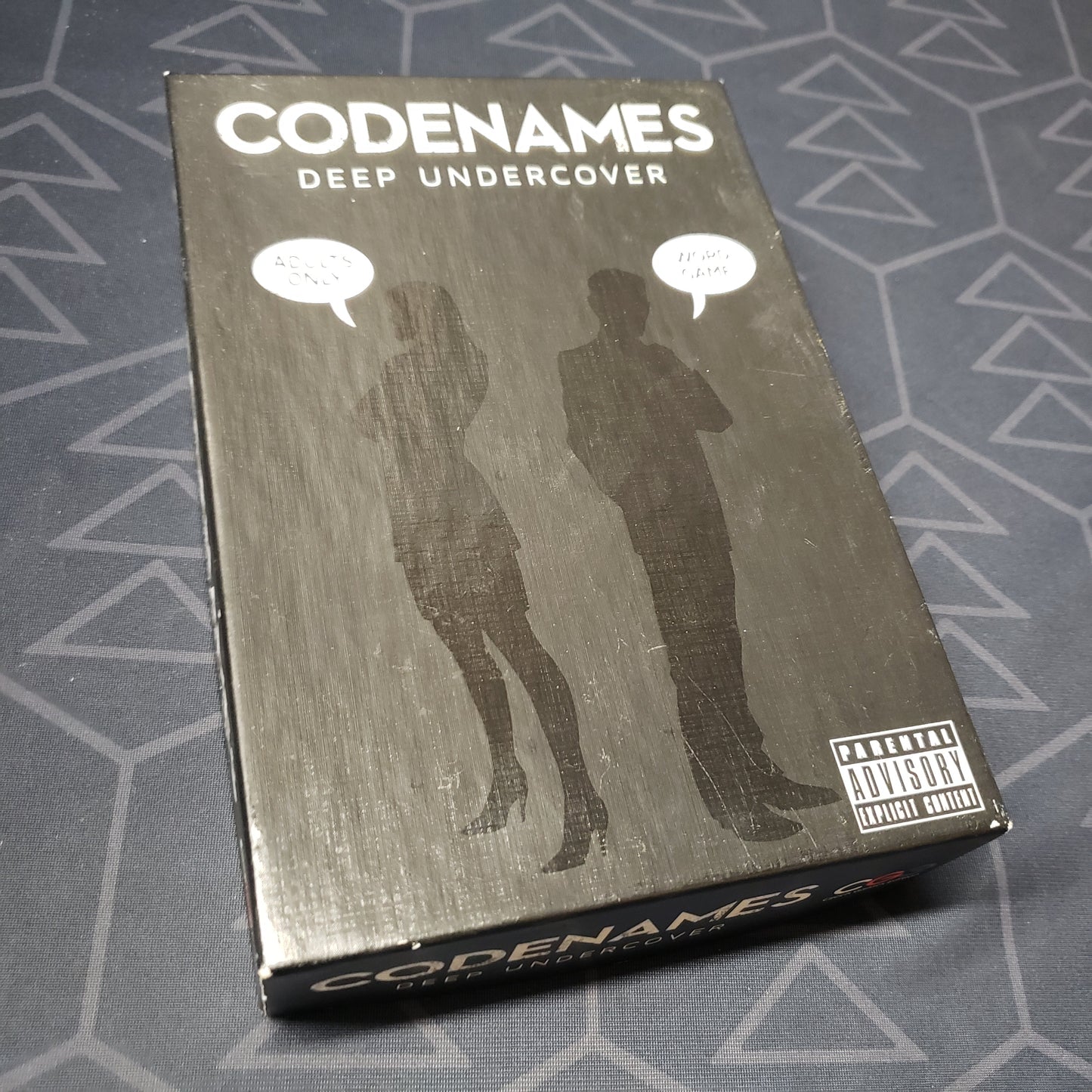 Image shows the front cover of the box of the Codenames: Deep Undercover card game