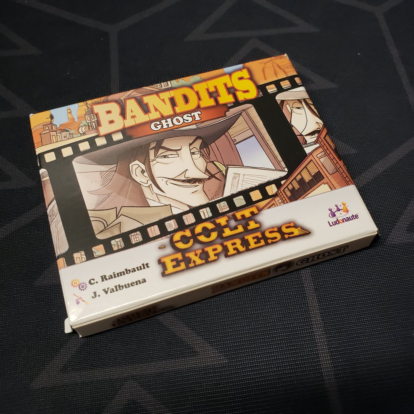 Image shows the front cover of the box of the Bandits: Ghost expansion for the board game Colt Express