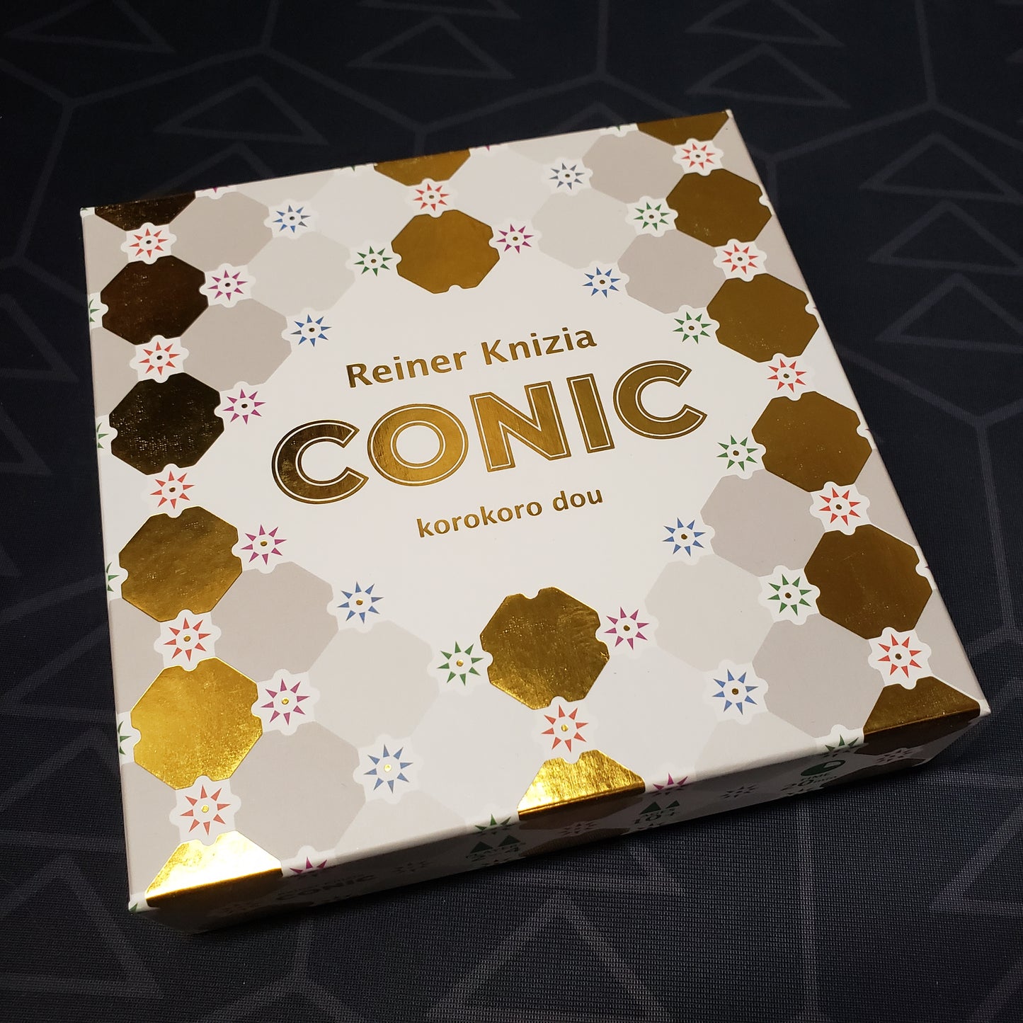 Image shows the front cover of the box for the CONIC board game