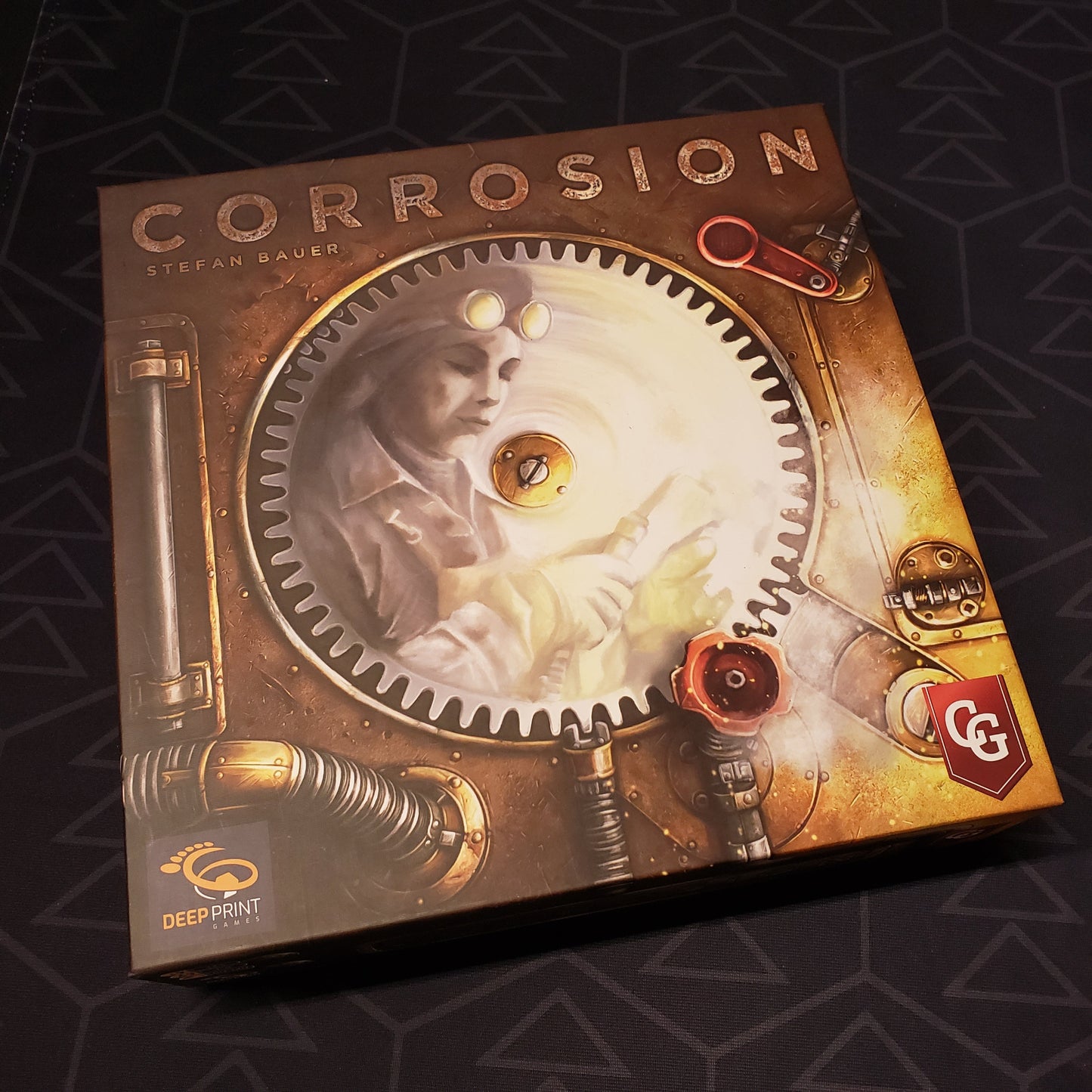 Image shows the front cover of the box of the Corrosion board game