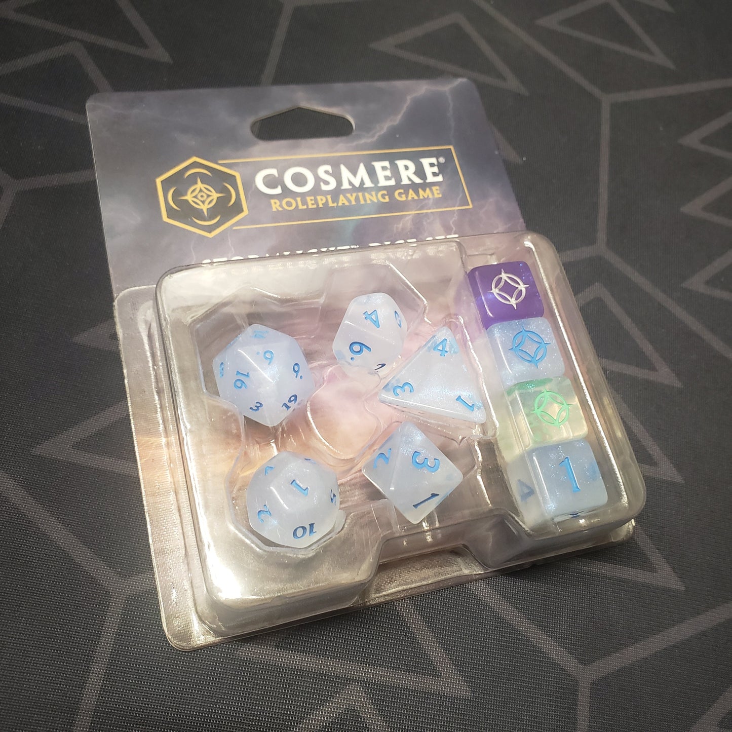 Image shows the front of the package of the Stormlight Dice set for the roleplaying game Cosmere