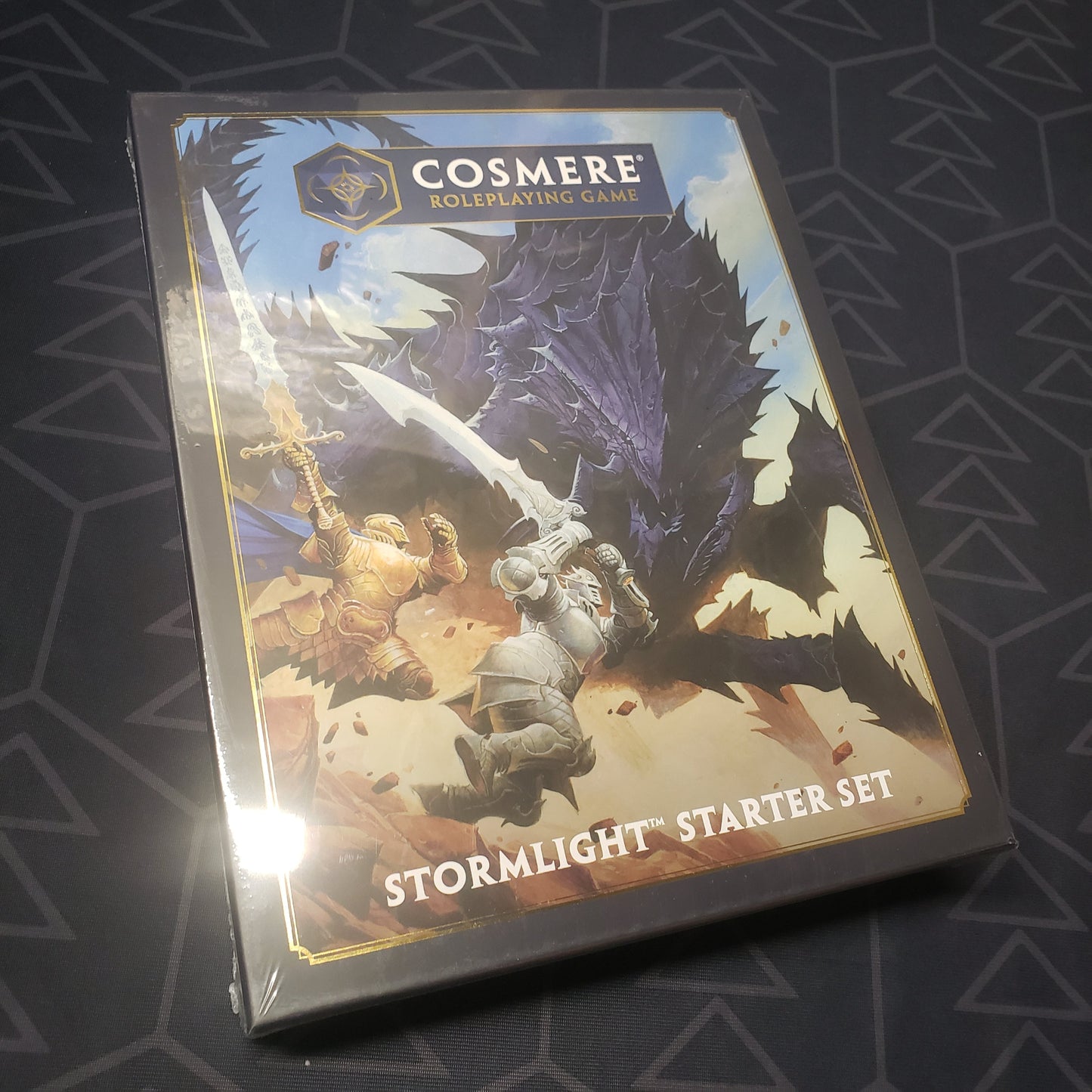Image shows the front cover of the Stormlight Starter Set box for the roleplaying game Cosmere