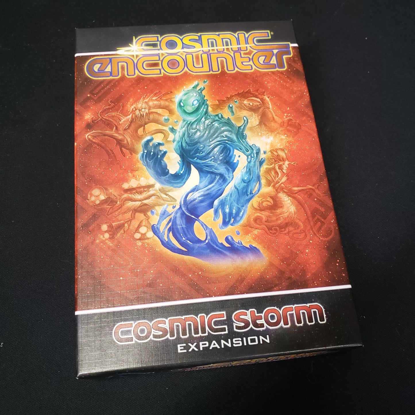 Image shows the front cover of the box of the Cosmic Storm expansion for the board game Cosmic Encounter