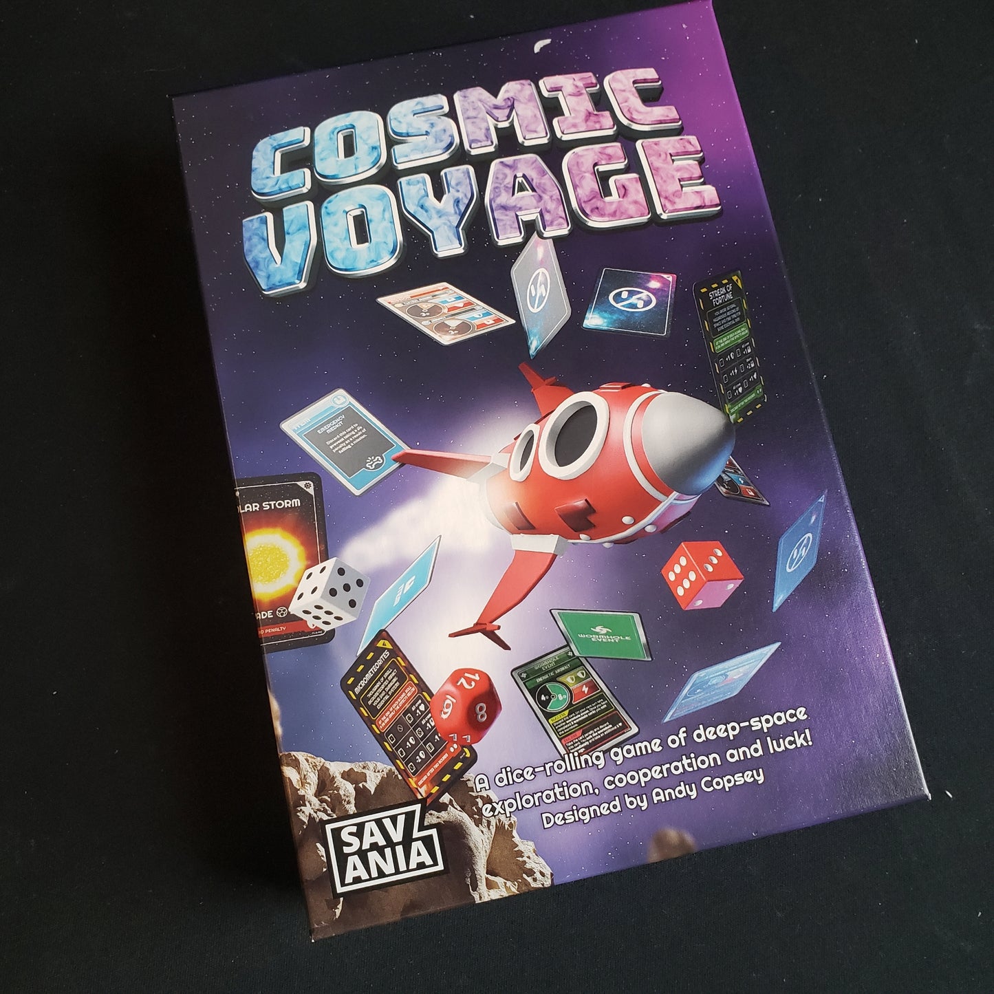 Image shows the front cover of the box of the Cosmic Voyage board game