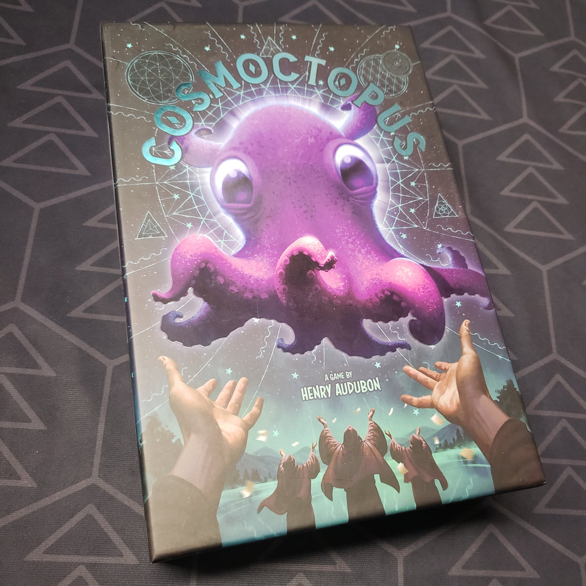 Image shows the front cover of the box for the Cosmoctopus board game