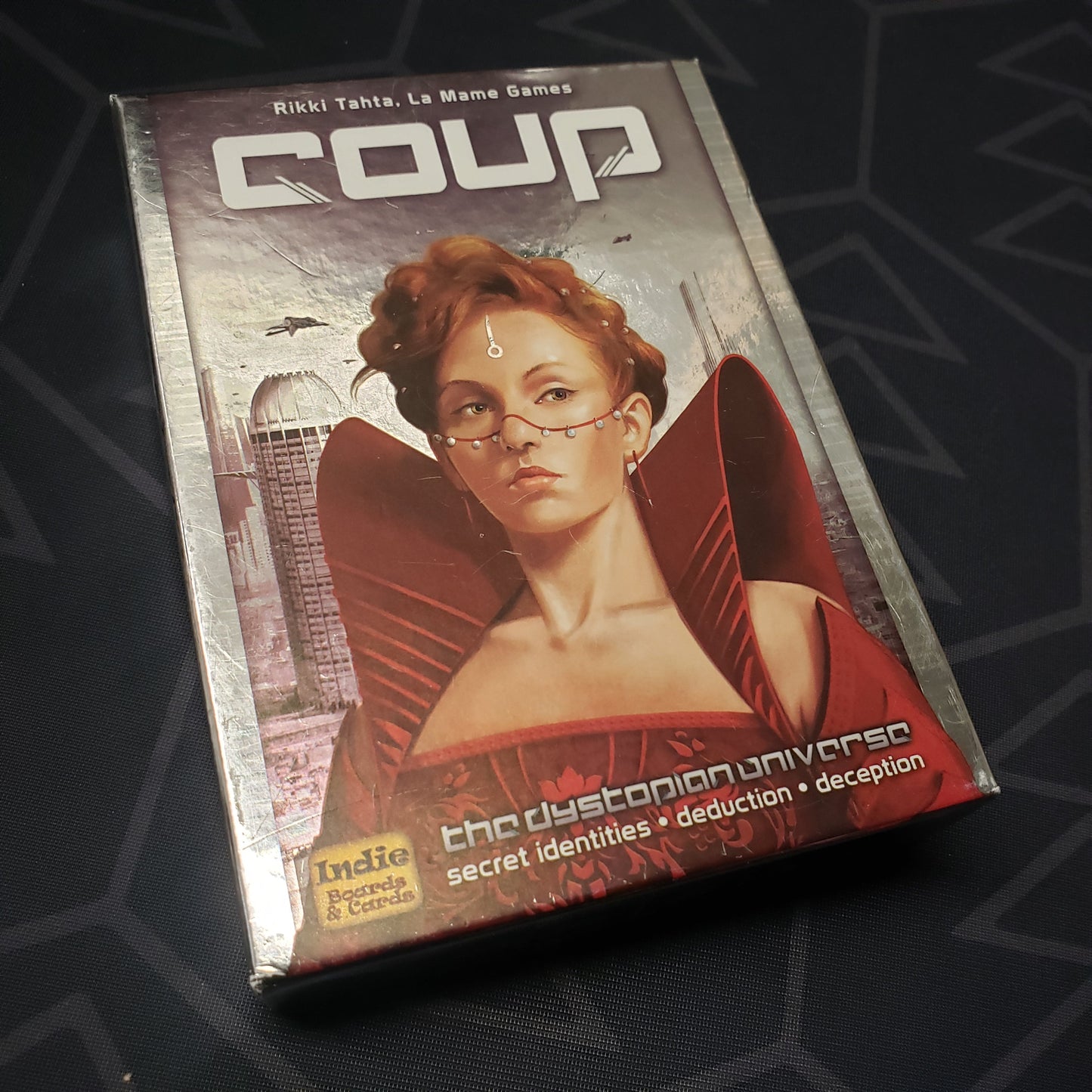 Image shows the front cover of the box of the card game Coup