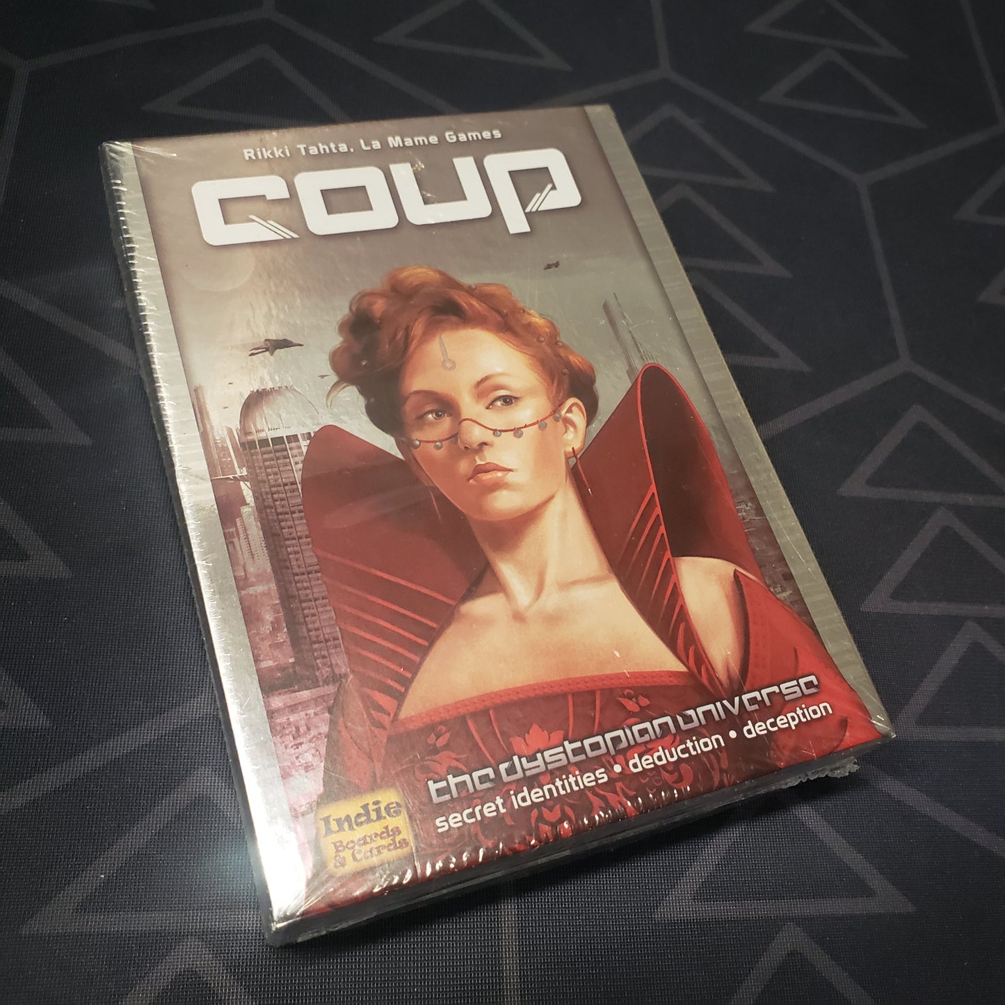 Image shows the front cover of the box of the card game Coup