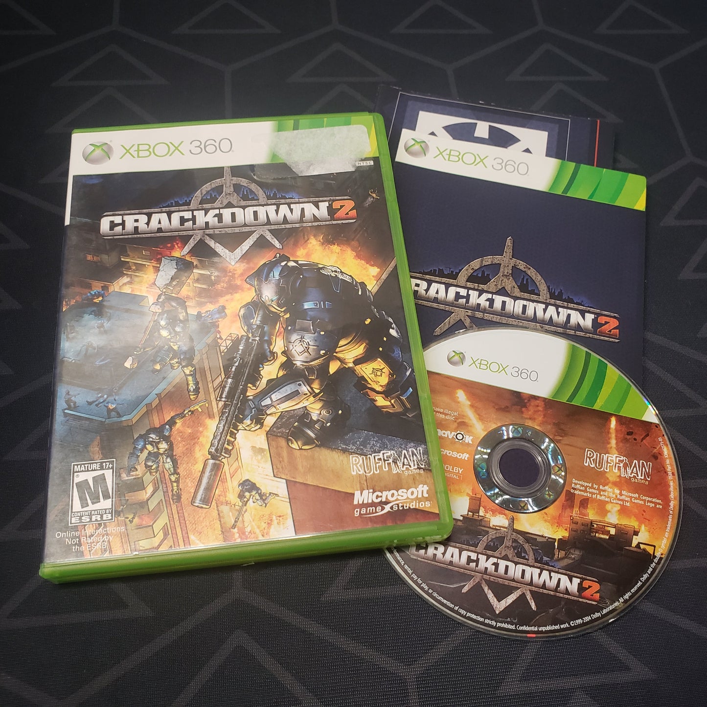 Image shows the case, manual and disc for the video game Crackdown 2 for Xbox 360