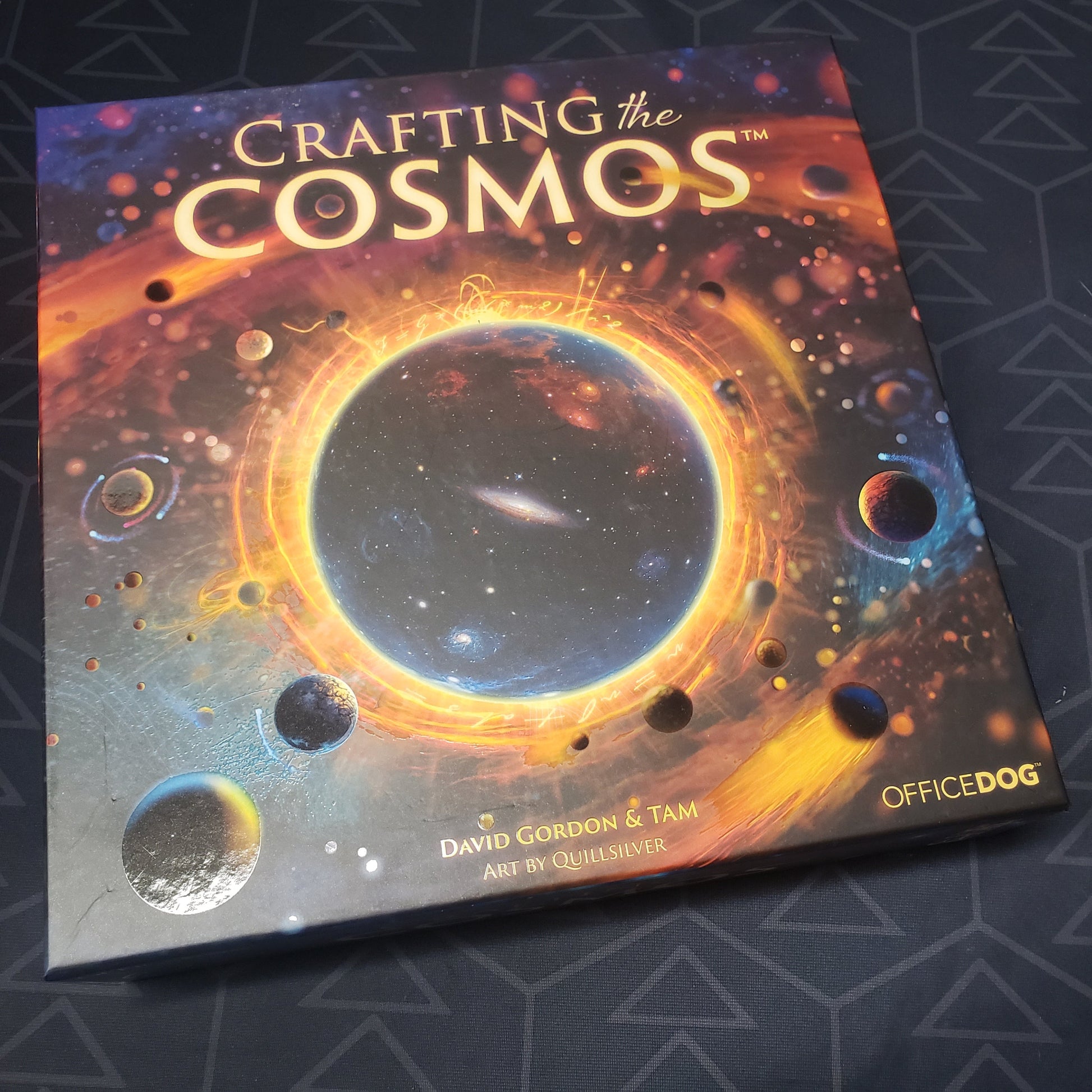 Image shows the front cover of the box for the Crafting the Cosmos board game